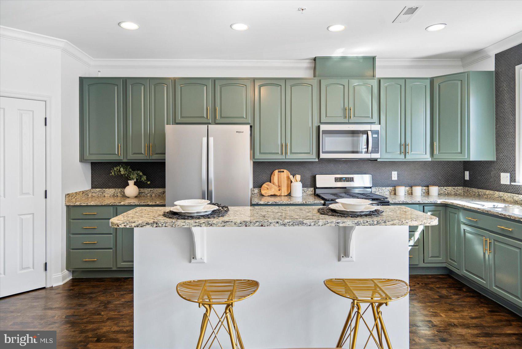 829 McHenry Street Baltimore, MD 21230 - Photo 17 of 41 a kitchen with stainless steel appliances granite countertop a stove a refrigerator a sink a dining table and chairs