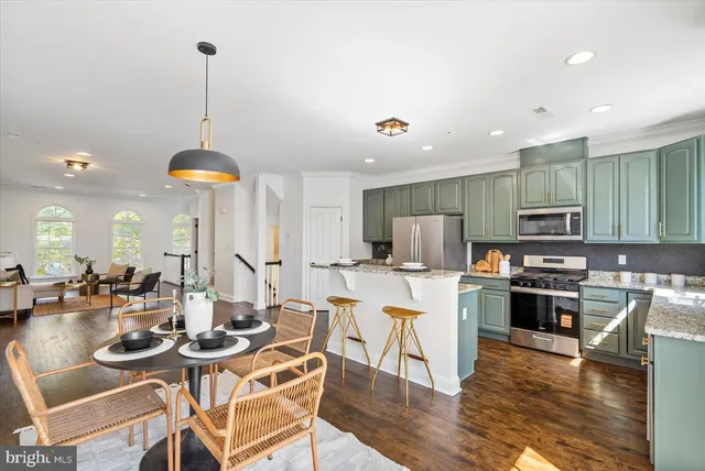 a kitchen with stainless steel appliances kitchen island granite countertop a sink and cabinets