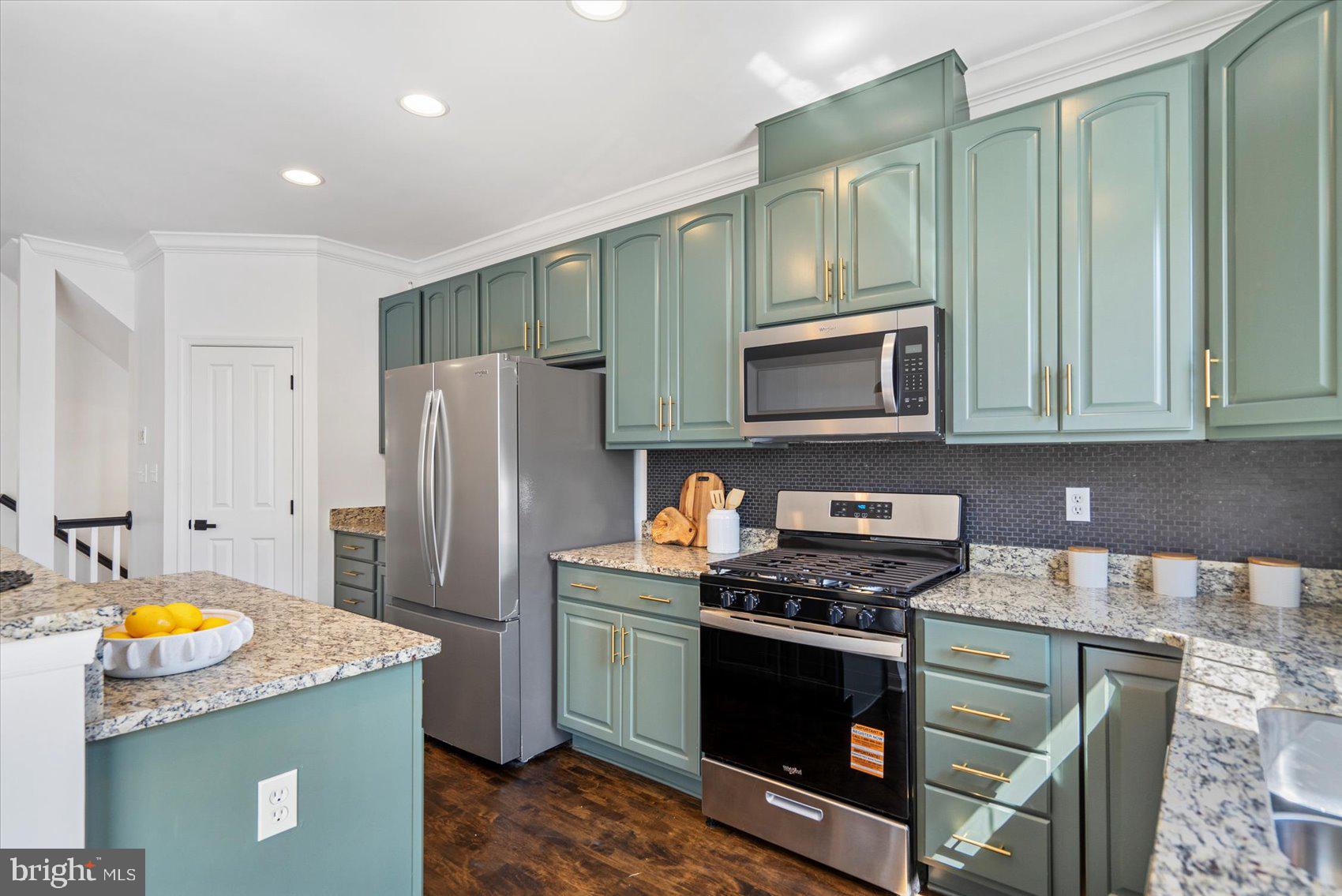 829 McHenry Street Baltimore, MD 21230 - Photo 19 of 41 a kitchen with stainless steel appliances granite countertop a stove a refrigerator and a microwave