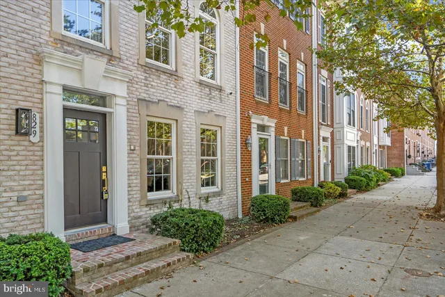 a view of a brick building next to a yard