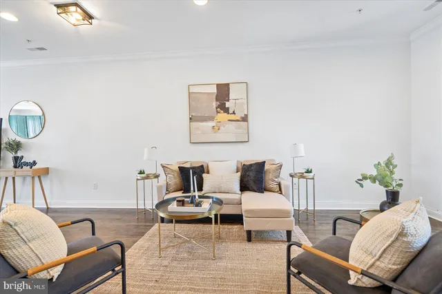 a living room with furniture a dining table and chairs