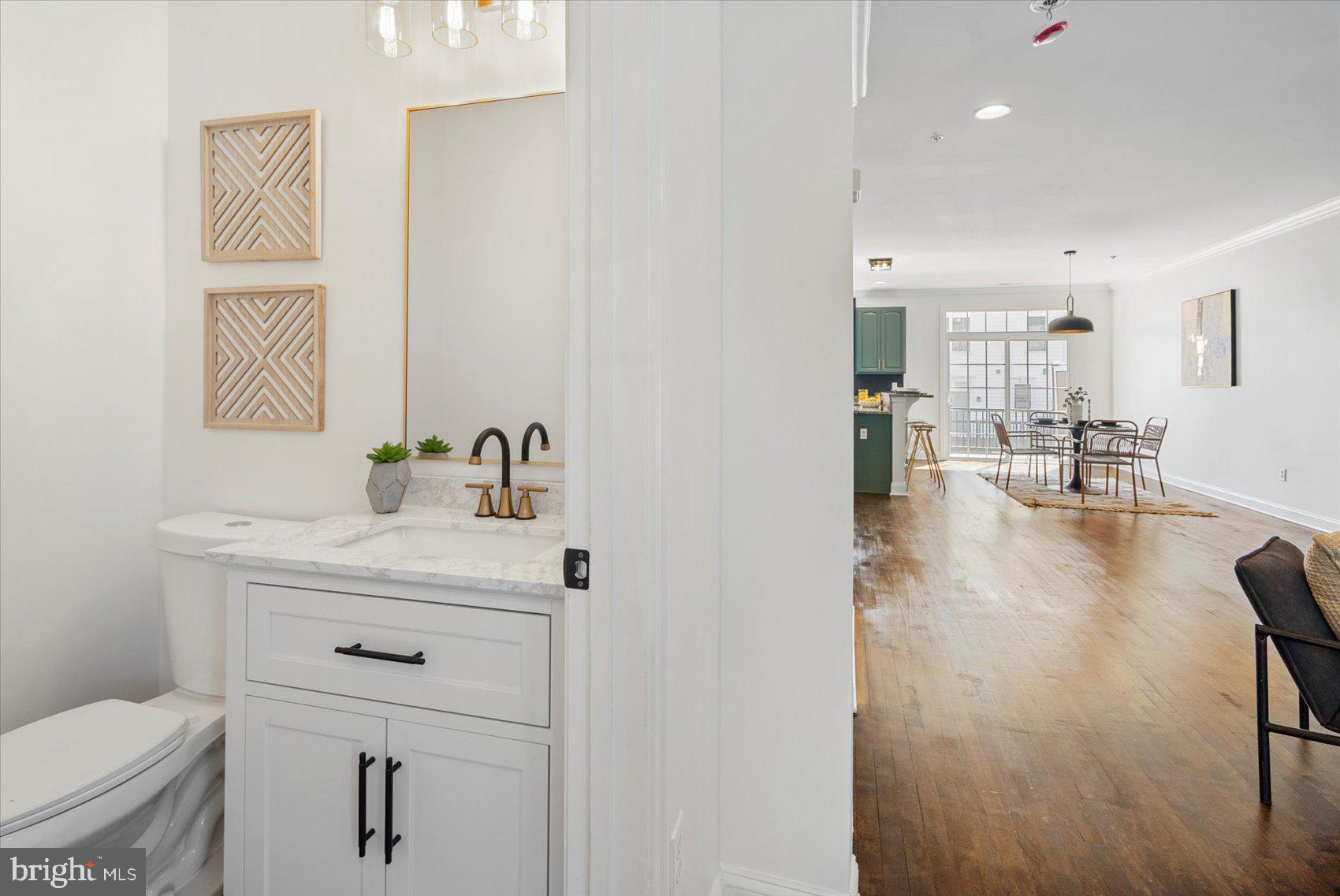 829 McHenry Street Baltimore, MD 21230 - Photo 26 of 41 a bathroom with a sink a toilet and a mirror