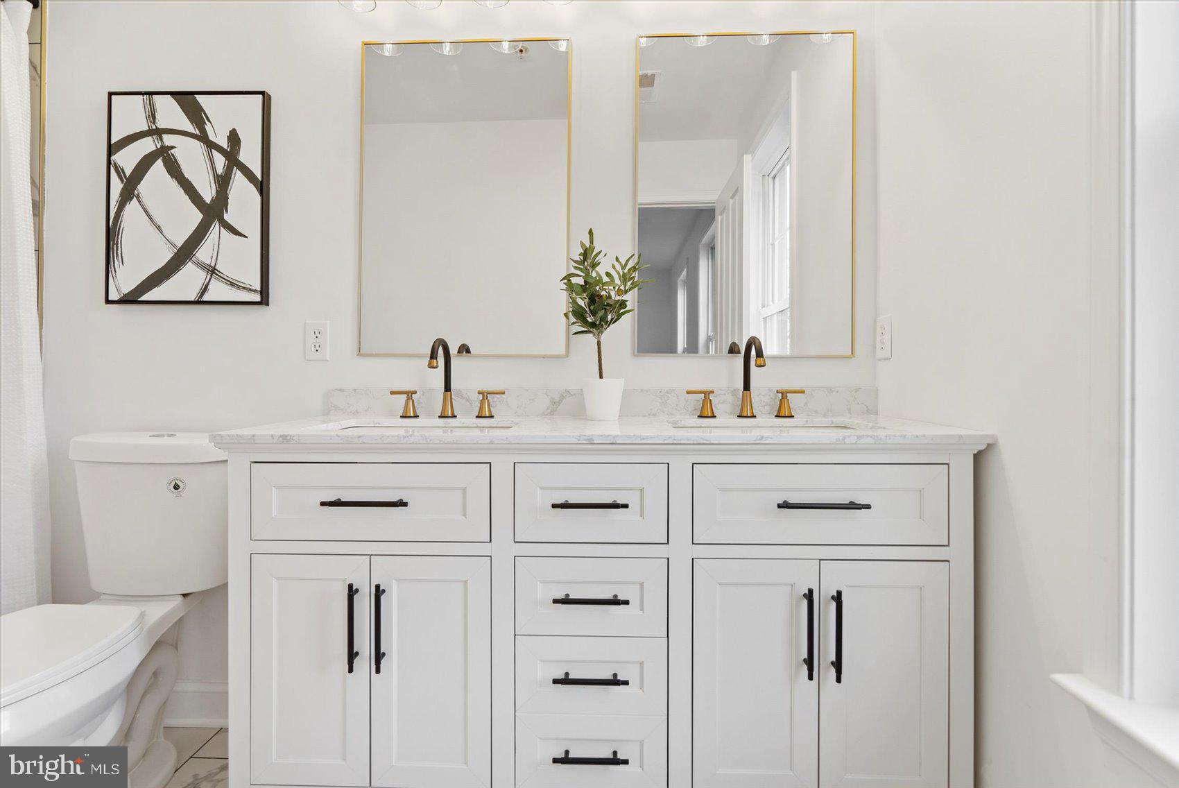 829 McHenry Street Baltimore, MD 21230 - Photo 30 of 41 a bathroom with double vanity sink two mirror and a
