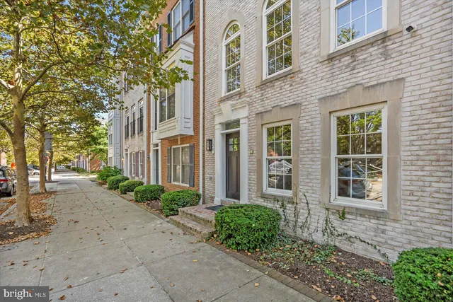a view of a brick building next to a yard