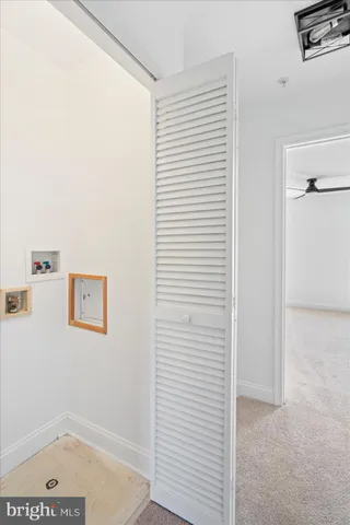 a bedroom with a bed and painting on the wall