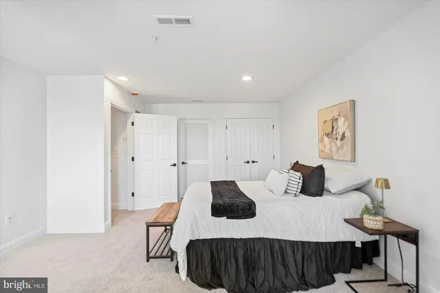 a bedroom with a bed and a cabinets