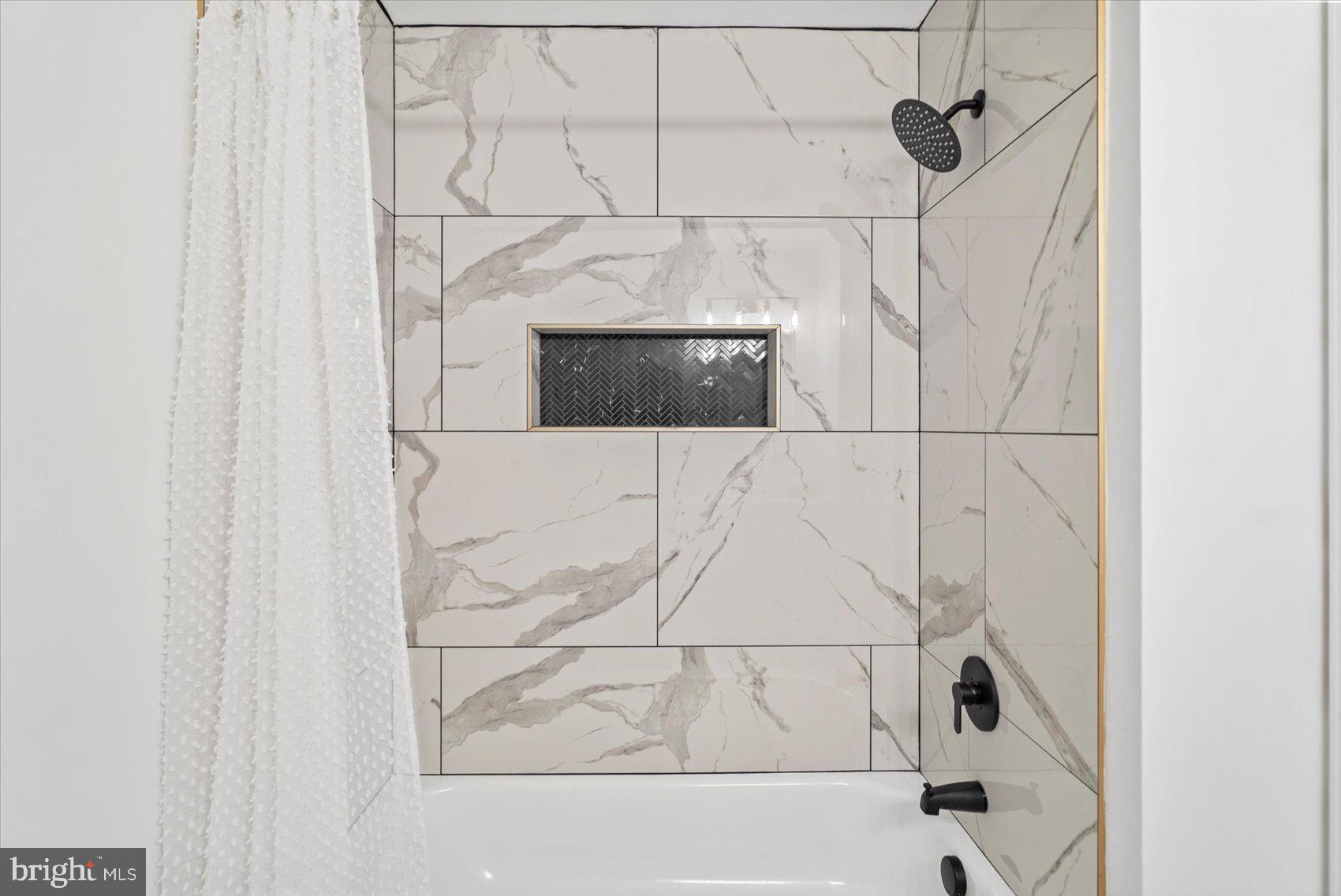 829 McHenry Street Baltimore, MD 21230 - Photo 9 of 41 a bathroom with a bathtub and shower