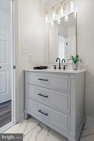 a bathroom with a sink vanity and a mirror