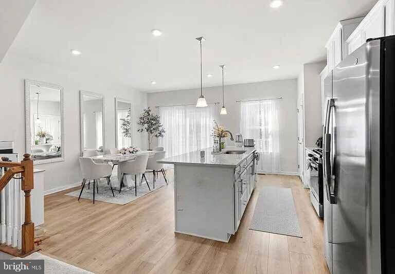 31 Continental Boulevard Sicklerville, NJ 08081 - Photo 12 of 29 a kitchen with stainless steel appliances a dining table chairs a sink dishwasher a refrigerator and microwave