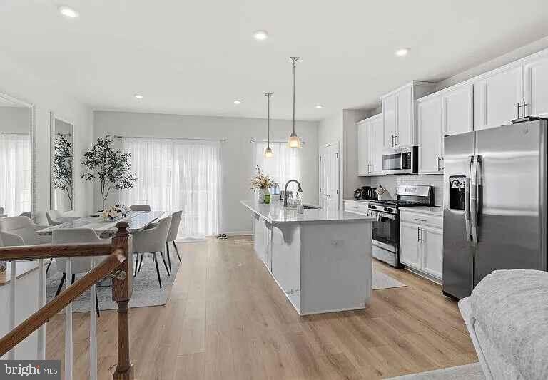 31 Continental Boulevard Sicklerville, NJ 08081 - Photo 13 of 29 a kitchen with a center island wooden floor stainless steel appliances and cabinets