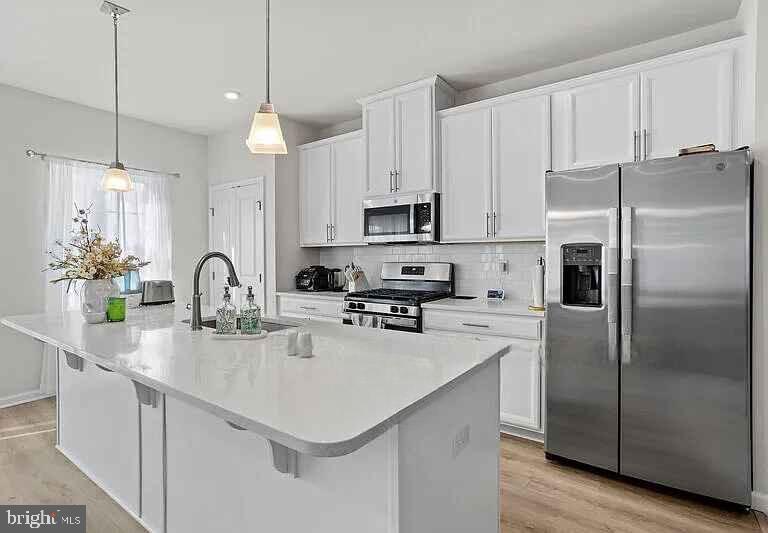 31 Continental Boulevard Sicklerville, NJ 08081 - Photo 14 of 29 a kitchen with kitchen island a counter space a sink appliances and cabinets