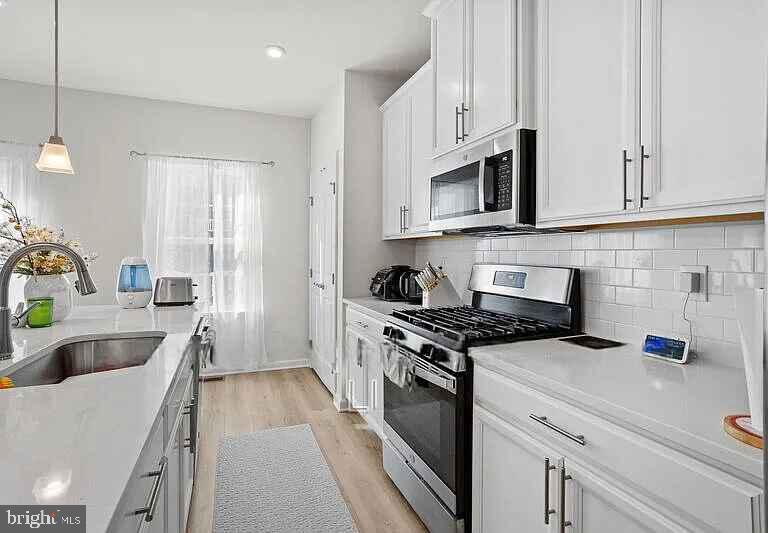 31 Continental Boulevard Sicklerville, NJ 08081 - Photo 16 of 29 a kitchen with stainless steel appliances granite countertop a sink stove and refrigerator