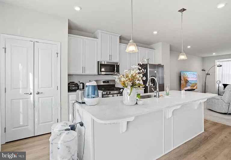 31 Continental Boulevard Sicklerville, NJ 08081 - Photo 17 of 29 a kitchen with stainless steel appliances kitchen island granite countertop a refrigerator a stove a sink and white cabinets with wooden floor