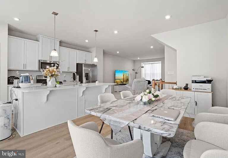 31 Continental Boulevard Sicklerville, NJ 08081 - Photo 20 of 29 a kitchen with stainless steel appliances kitchen island granite countertop a kitchen island a stove a table and chairs