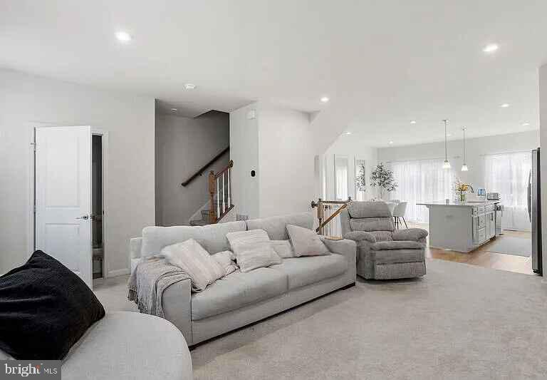 31 Continental Boulevard Sicklerville, NJ 08081 - Photo 8 of 29 a living room with furniture and a lamp