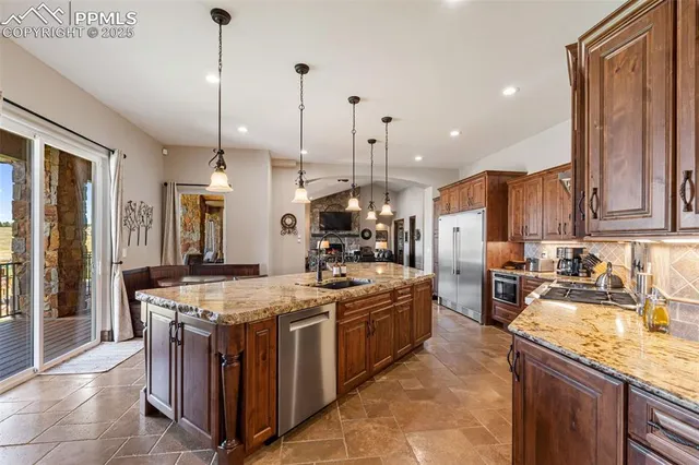 a kitchen with a stove sink and refrigerator