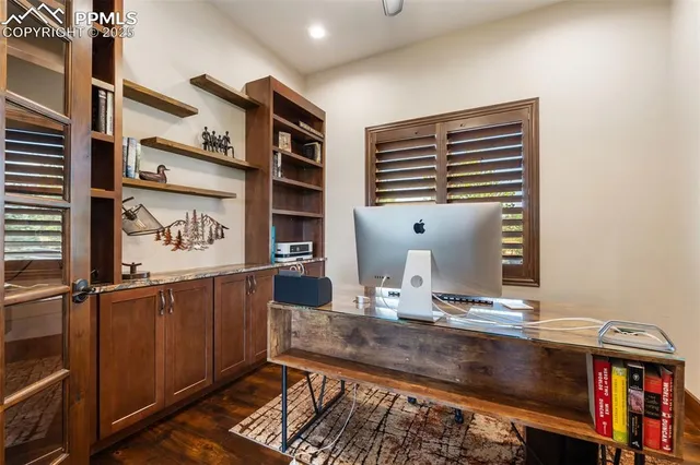 a view of kitchen with cabinets and window