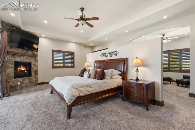 a spacious bedroom with a bed and a fireplace