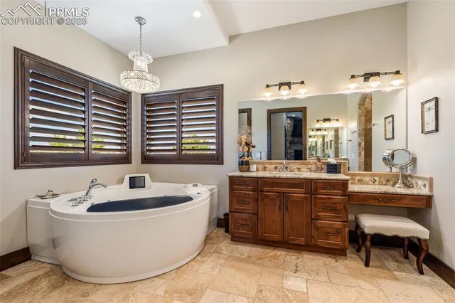 a spacious bathroom with a tub sink and mirror