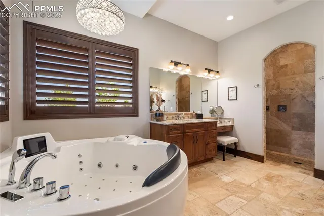 a large bathroom with a tub sink and mirror