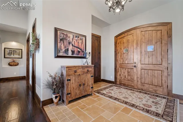 a view of a hallway with wooden floor and a workspace