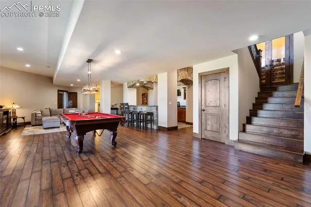 a room with lots of wooden furniture and chairs