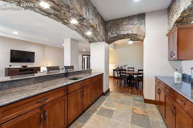 a large kitchen with a large counter top appliances and cabinets