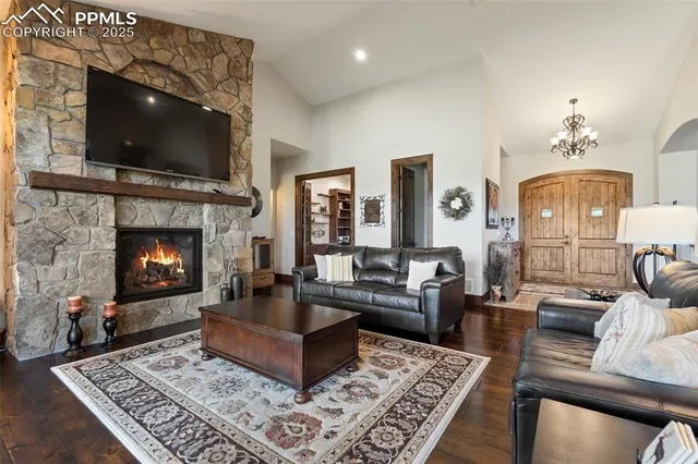 a living room with furniture a flat screen tv and a fireplace