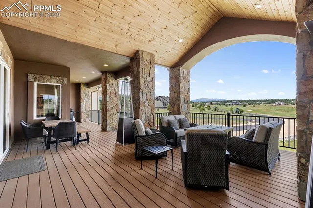 a living room with furniture and floor to ceiling windows