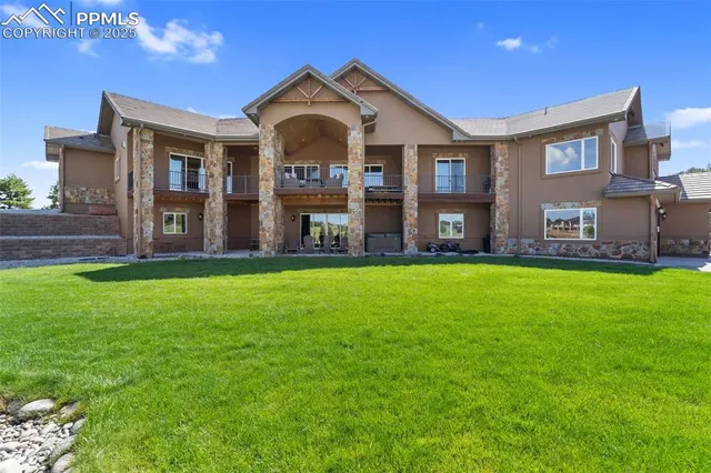 a view of a big house with a swimming pool