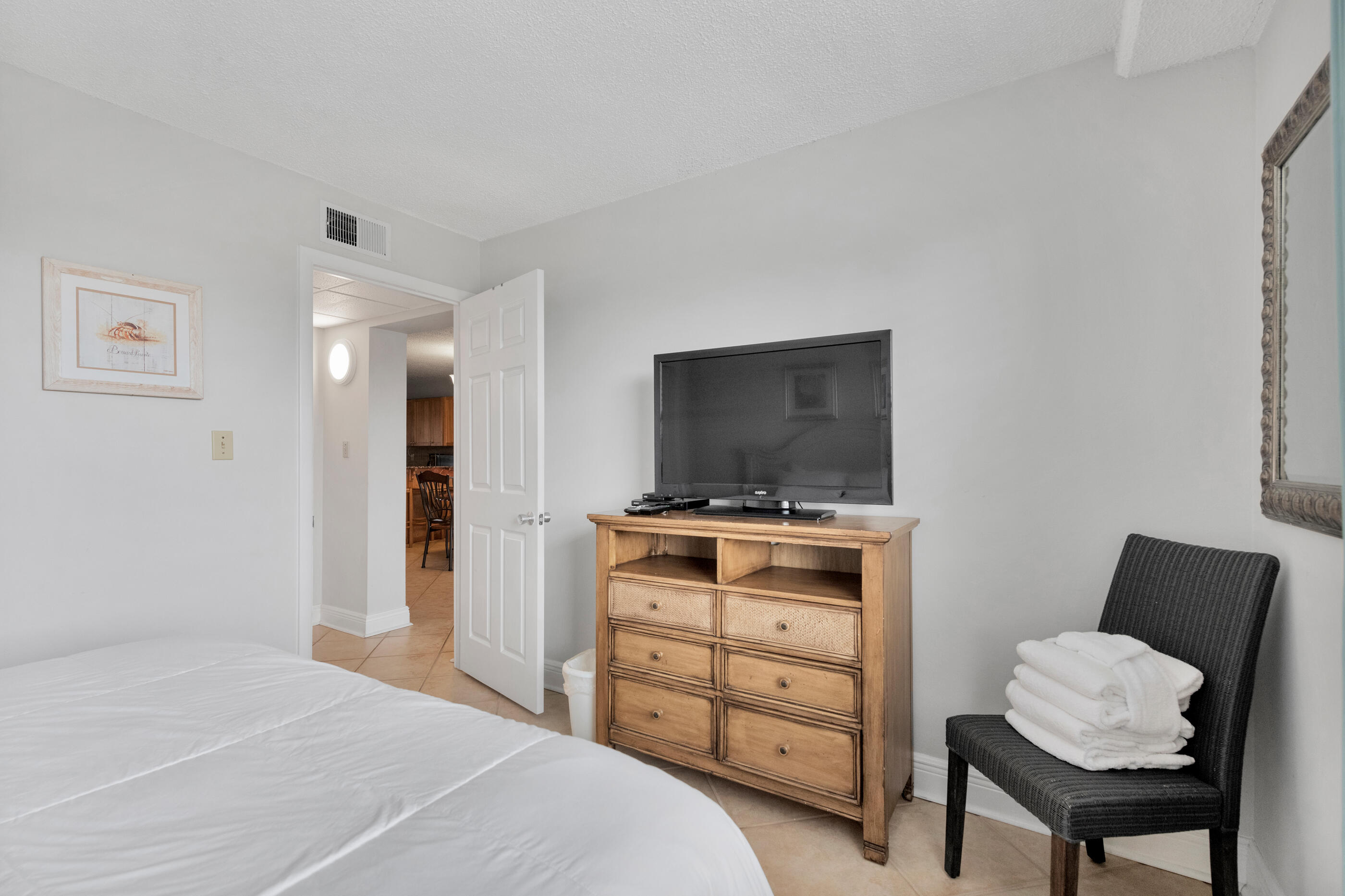 885 Santa Rosa Boulevard, Unit 208 Fort Walton Beach, FL 32548 - Photo 3 of 15 a bedroom with a bed and a television