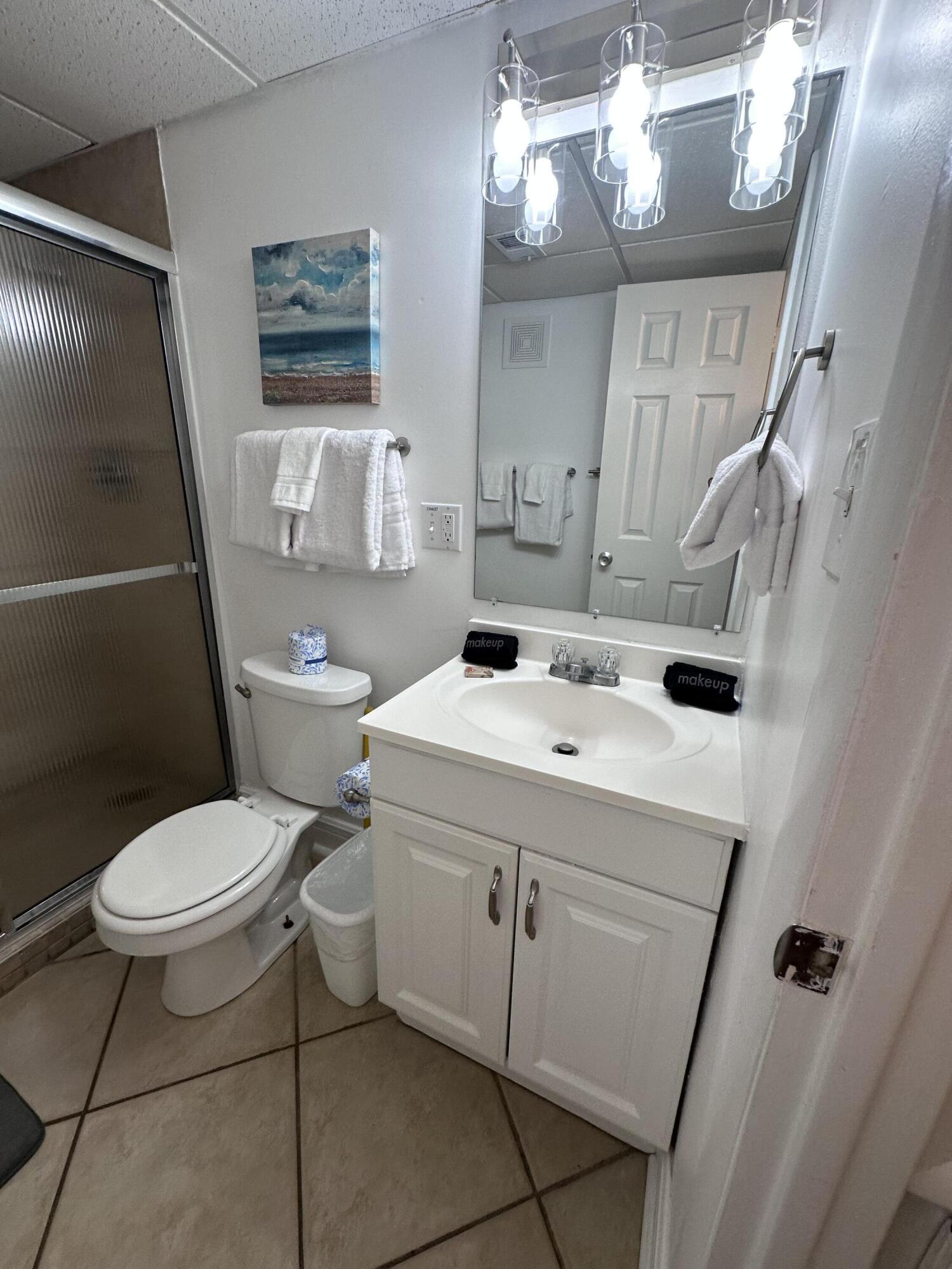 885 Santa Rosa Boulevard, Unit 208 Fort Walton Beach, FL 32548 - Photo 4 of 15 a bathroom with a sink toilet and a mirror