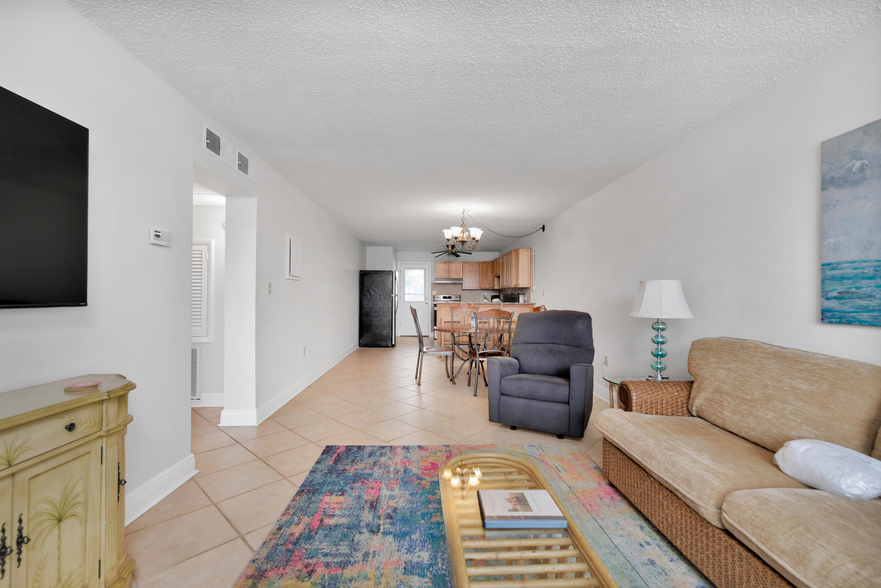 885 Santa Rosa Boulevard, Unit 208 Fort Walton Beach, FL 32548 - Photo 6 of 15 a living room with furniture and a flat screen tv