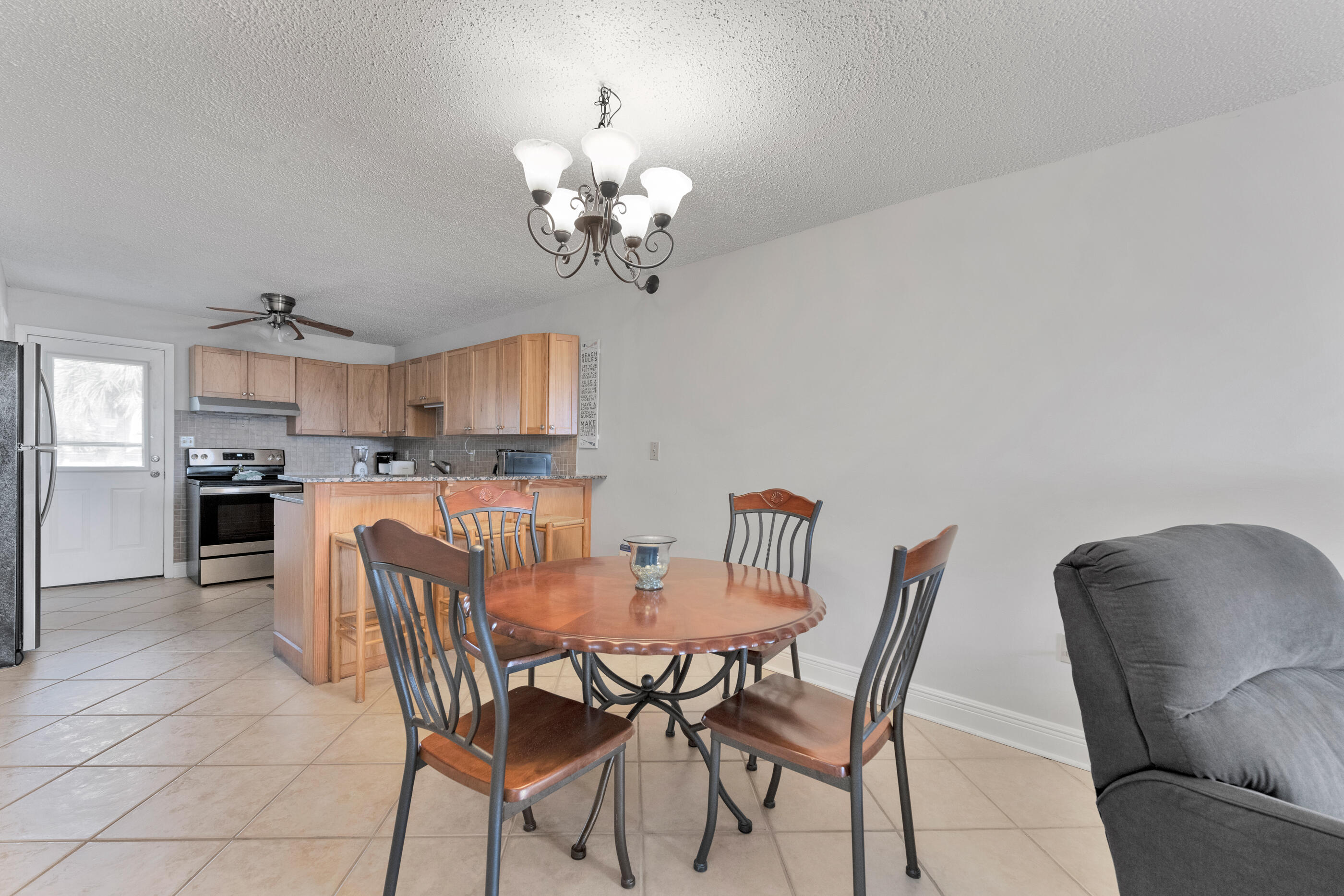 885 Santa Rosa Boulevard, Unit 208 Fort Walton Beach, FL 32548 - Photo 9 of 15 a view of a dining room with furniture and chandelier