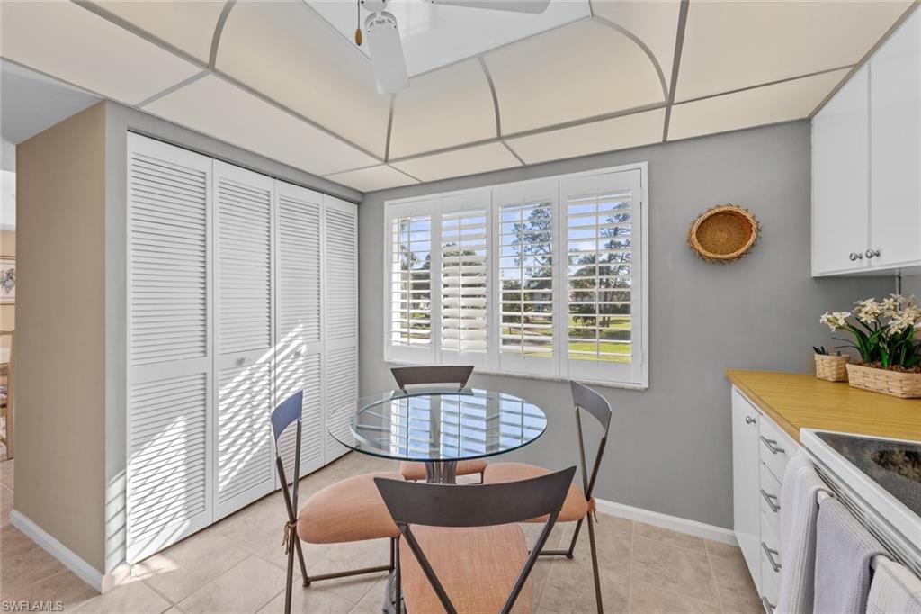 273 Albi Road, Unit 4 Naples, FL 34112 - Photo 14 of 50 Dining room with a paneled ceiling, ceiling fan, and light tile patterned flooring