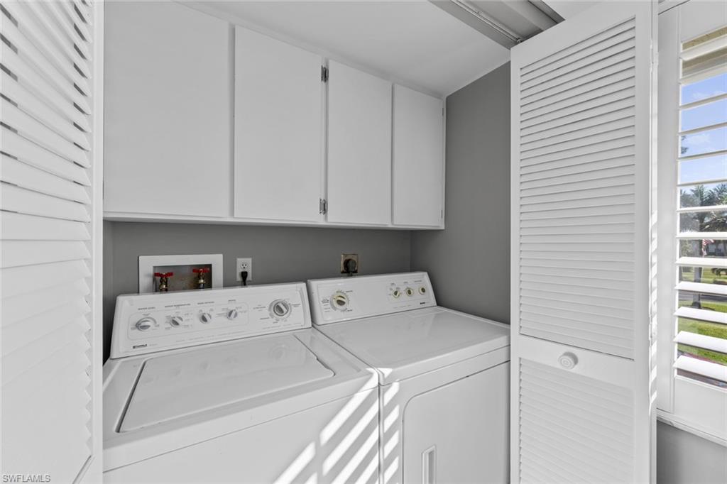 273 Albi Road, Unit 4 Naples, FL 34112 - Photo 17 of 50 Laundry room featuring cabinets and independent washer and dryer