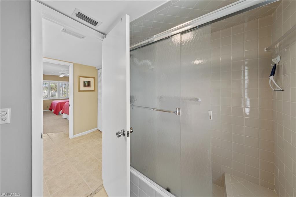 273 Albi Road, Unit 4 Naples, FL 34112 - Photo 22 of 50 Bathroom featuring tile patterned flooring and a shower with shower door