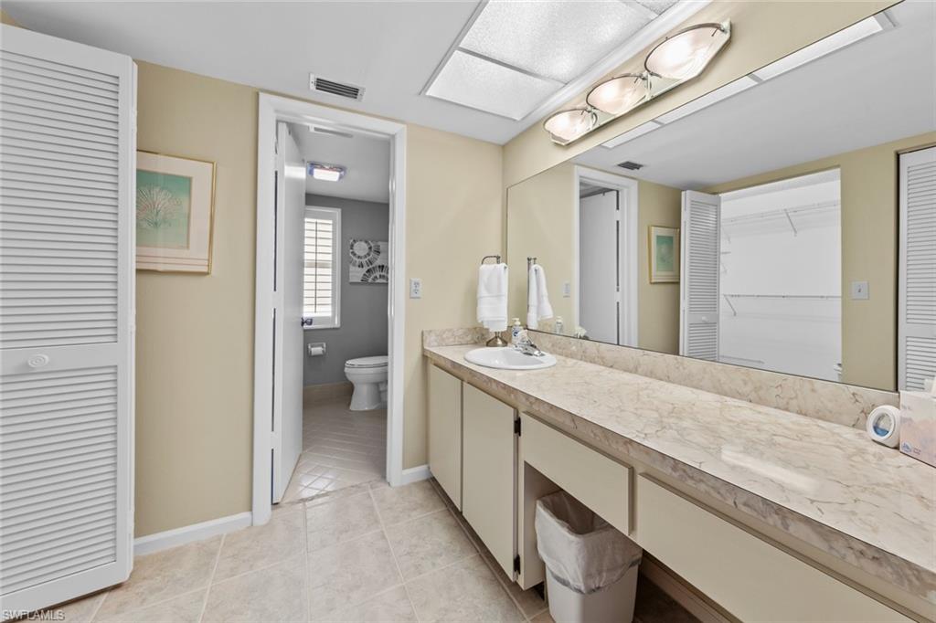 273 Albi Road, Unit 4 Naples, FL 34112 - Photo 25 of 50 Bathroom featuring tile patterned flooring, vanity, and toilet