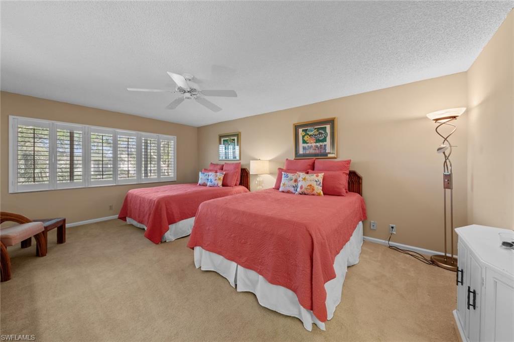273 Albi Road, Unit 4 Naples, FL 34112 - Photo 27 of 50 Bedroom featuring light carpet, a textured ceiling, and ceiling fan