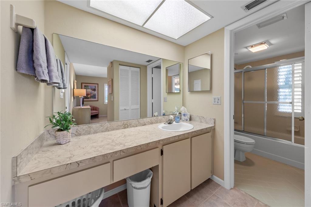 273 Albi Road, Unit 4 Naples, FL 34112 - Photo 29 of 50 Full bathroom with tile patterned floors, vanity, toilet, and shower / bath combination with glass door