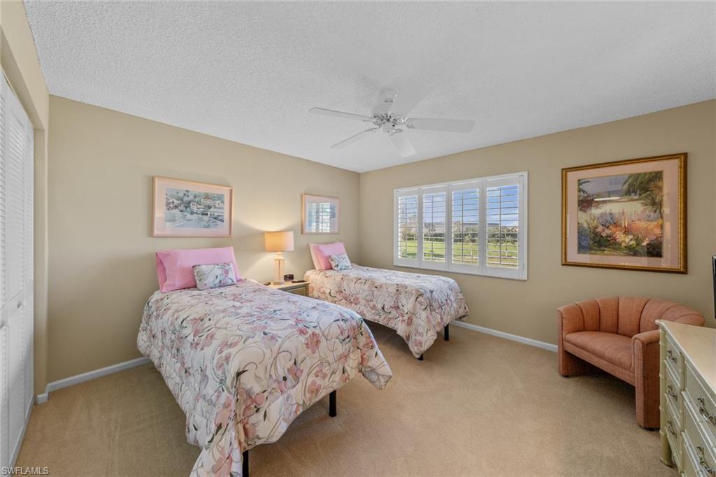 273 Albi Road, Unit 4 Naples, FL 34112 - Photo 31 of 50 Bedroom featuring a closet, ceiling fan, and light colored carpet