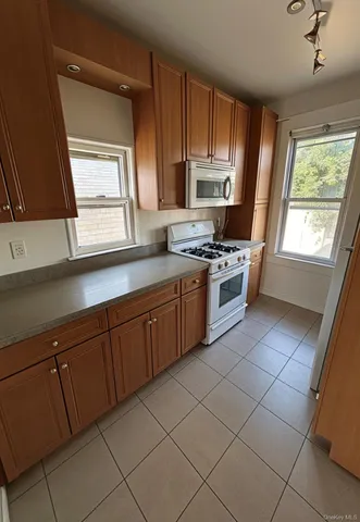 a kitchen with a sink a stove and cabinets