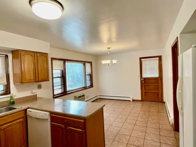a kitchen with stainless steel appliances granite countertop a stove and a refrigerator