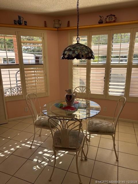 3480 Southeast Martinique Trace, Unit 102 Stuart, FL 34997 - Photo 11 of 24 a view of a dining room with furniture window and outside view