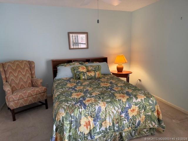 3480 Southeast Martinique Trace, Unit 102 Stuart, FL 34997 - Photo 16 of 24 a bedroom with a bed and a couch