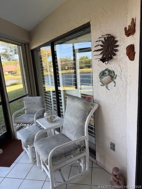 3480 Southeast Martinique Trace, Unit 102 Stuart, FL 34997 - Photo 19 of 24 a living room with furniture and floor to ceiling windows