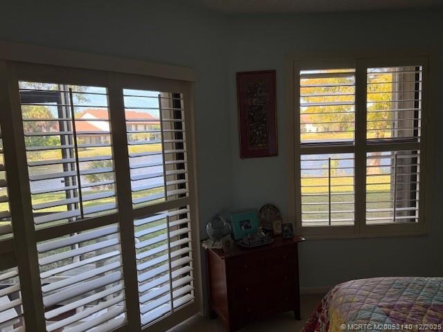 3480 Southeast Martinique Trace, Unit 102 Stuart, FL 34997 - Photo 4 of 24 a bedroom with a bed and a window
