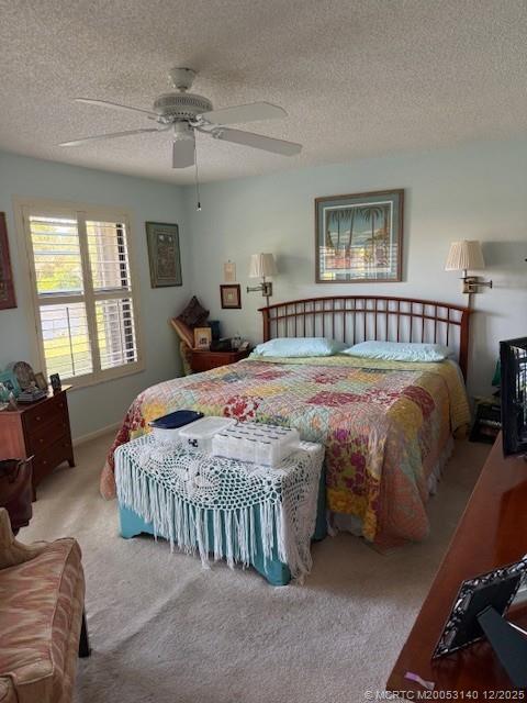 3480 Southeast Martinique Trace, Unit 102 Stuart, FL 34997 - Photo 5 of 24 a bedroom with a bed a couch and dresser