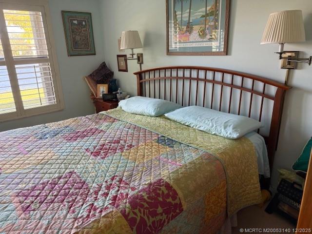 3480 Southeast Martinique Trace, Unit 102 Stuart, FL 34997 - Photo 6 of 24 a bedroom with a bed and a window