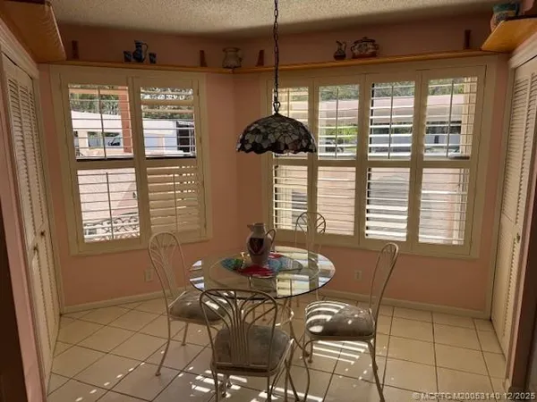a view of a dining room with furniture window and outside view